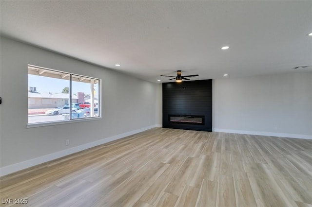 6100 Fawn Cir, Las Vegas, NV 89107 - unfurnished living room with light wood-style floors, a ceiling fan, a fireplace, recessed lighting, and baseboards