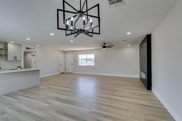 6100 Fawn Cir, Las Vegas, NV 89107 - unfurnished living room featuring recessed lighting, a chandelier, baseboards, a fireplace, and a ceiling fan