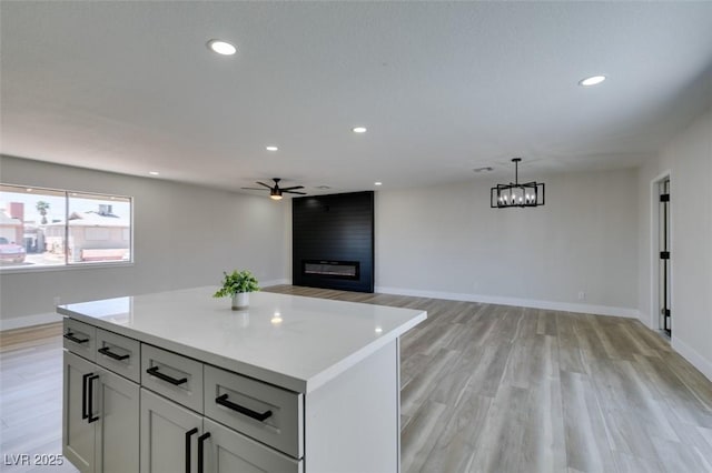 6100 Fawn Cir, Las Vegas, NV 89107 - kitchen with a large fireplace, a ceiling fan, light countertops, baseboards, and recessed lighting