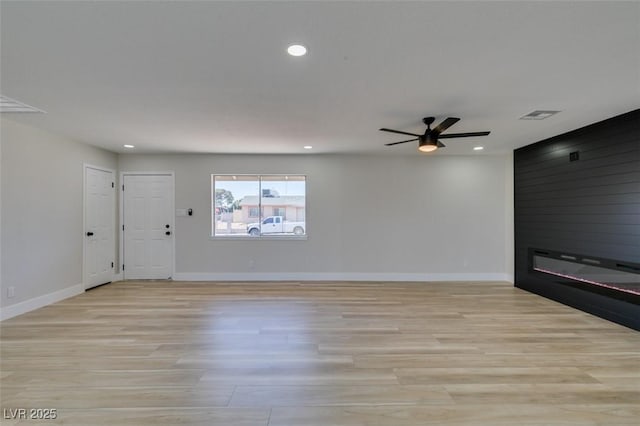 6100 Fawn Cir, Las Vegas, NV 89107 - unfurnished living room with light wood-style floors, ceiling fan, baseboards, and recessed lighting