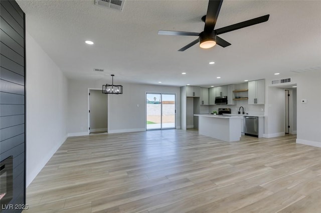 6100 Fawn Cir, Las Vegas, NV 89107 - unfurnished living room featuring a sink, a ceiling fan, light wood-type flooring, a chandelier, and recessed lighting