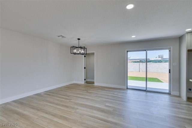 6100 Fawn Cir, Las Vegas, NV 89107 - spare room featuring light wood-type flooring, a chandelier, recessed lighting, and baseboards
