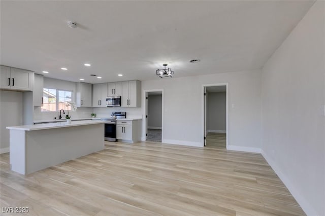 4360 El Tovar Rd, Las Vegas, NV 89115 - kitchen featuring appliances with stainless steel finishes, baseboards, light countertops, and recessed lighting