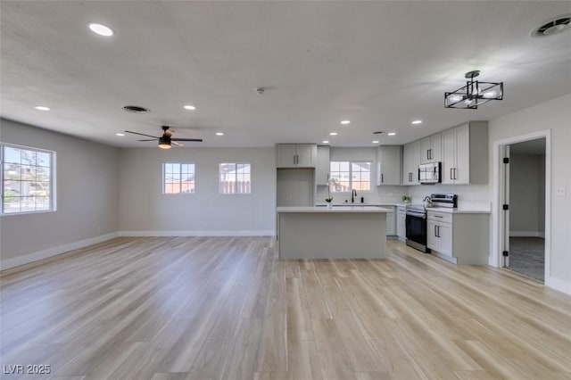 4360 El Tovar Rd, Las Vegas, NV 89115 - kitchen featuring appliances with stainless steel finishes, baseboards, recessed lighting, a sink, and light wood finished floors
