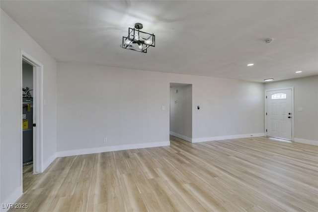4360 El Tovar Rd, Las Vegas, NV 89115 - empty room with light wood-style flooring, water heater, baseboards, recessed lighting, and a smoke detector