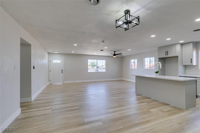 4360 El Tovar Rd, Las Vegas, NV 89115 - unfurnished living room featuring ceiling fan, healthy amount of natural light, recessed lighting, and baseboards