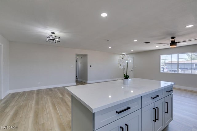 4360 El Tovar Rd, Las Vegas, NV 89115 - kitchen featuring open floor plan, light countertops, light wood-type flooring, a center island, and recessed lighting