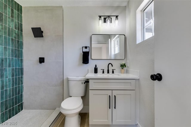 4360 El Tovar Rd, Las Vegas, NV 89115 - bathroom featuring vanity, toilet, and tiled shower