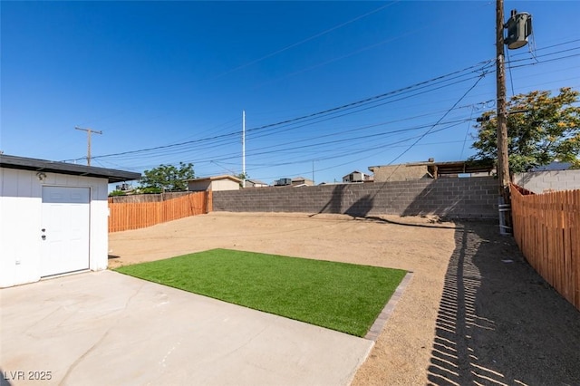 4360 El Tovar Rd, Las Vegas, NV 89115 - fenced backyard with a patio and an outbuilding