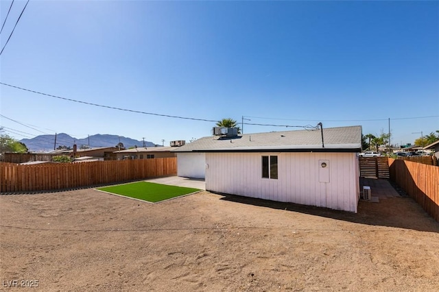 4360 El Tovar Rd, Las Vegas, NV 89115 - back of house featuring a mountain view, a fenced backyard, a patio area, and central AC unit