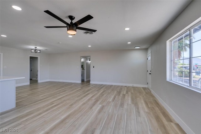 4360 El Tovar Rd, Las Vegas, NV 89115 - unfurnished living room featuring ceiling fan, recessed lighting, baseboards, light wood-style floors, and a chandelier