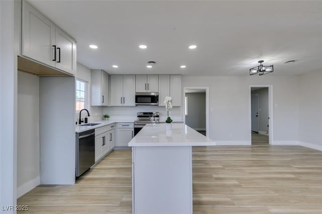 4360 El Tovar Rd, Las Vegas, NV 89115 - kitchen featuring stainless steel appliances, a sink, baseboards, a center island, and recessed lighting