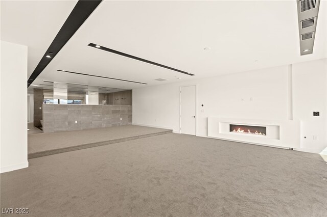 25 Canyon Bay Dr, Henderson, NV 89011 - unfurnished living room with a lit fireplace, carpet, and baseboards
