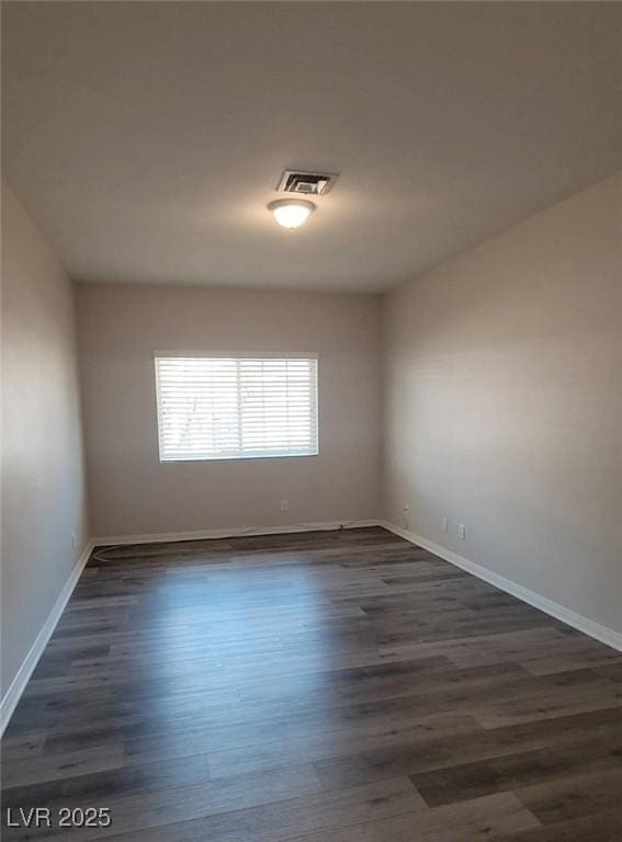 5509 Big Sky Ln, Las Vegas, NV 89149 - spare room featuring dark wood-style flooring and baseboards