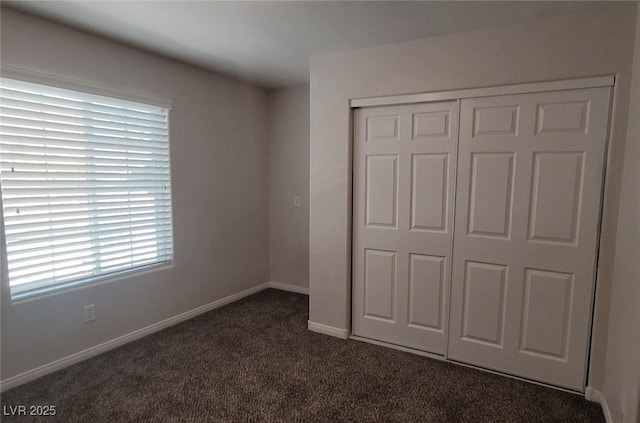5509 Big Sky Ln, Las Vegas, NV 89149 - unfurnished bedroom featuring dark colored carpet, a closet, and baseboards