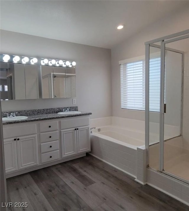 5509 Big Sky Ln, Las Vegas, NV 89149 - full bathroom with wood finished floors, a garden tub, double vanity, a stall shower, and recessed lighting