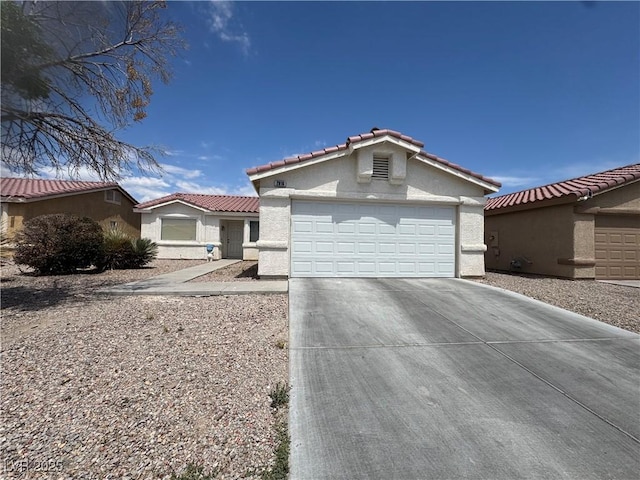 2916 Honeysuckle Ave, North Las Vegas, NV 89031 - view of front of property featuring an attached garage, concrete driveway, stucco siding, and a tiled roof