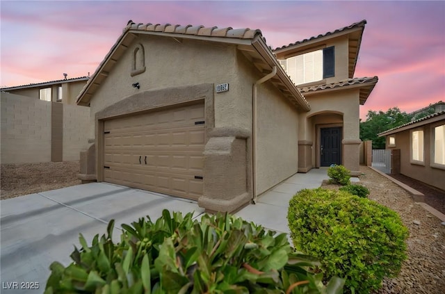 10952 Napa Ridge Dr, Las Vegas, NV 89144 - mediterranean / spanish-style home with an attached garage, stucco siding, a tile roof, and concrete driveway