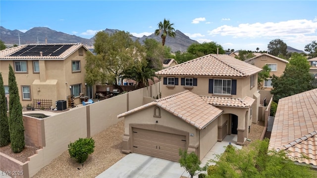 10952 Napa Ridge Dr, Las Vegas, NV 89144 - view of front of home with stucco siding, a mountain view, a fenced backyard, and an attached garage