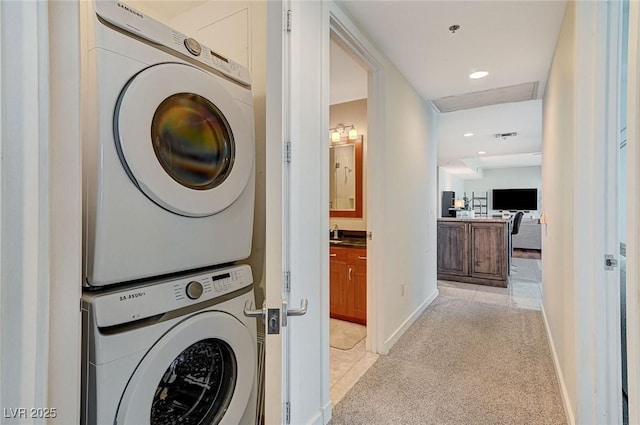 4525 Dean Martin Dr Unit 1208, Las Vegas, NV 89103 - laundry room featuring stacked washer and clothes dryer, light colored carpet, and recessed lighting