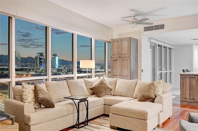 4525 Dean Martin Dr Unit 1208, Las Vegas, NV 89103 - living area with light wood-type flooring, a ceiling fan, and a city view