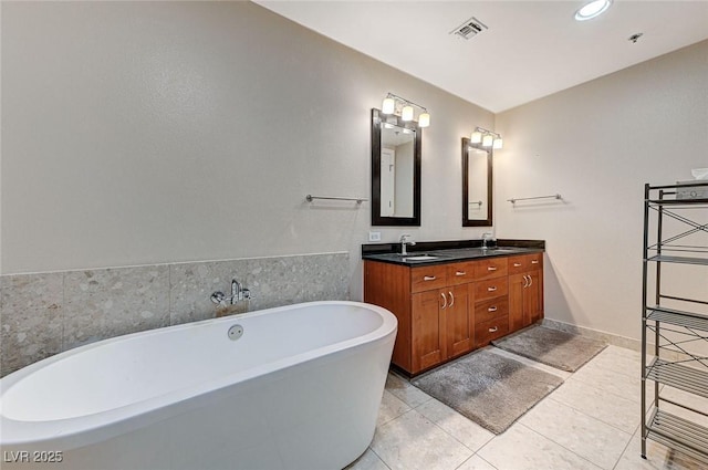 4525 Dean Martin Dr Unit 1208, Las Vegas, NV 89103 - full bath with a freestanding tub, double vanity, and tile patterned floors