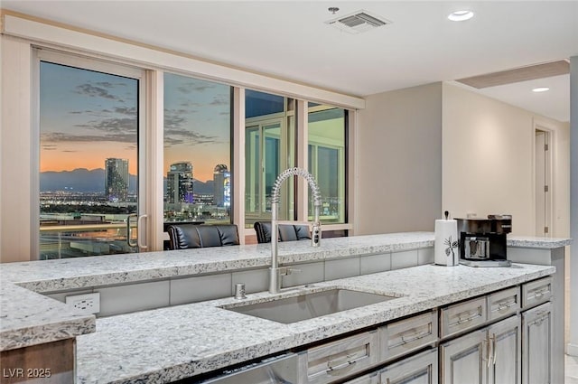 4525 Dean Martin Dr Unit 1208, Las Vegas, NV 89103 - kitchen featuring light stone counters, recessed lighting, and a city view