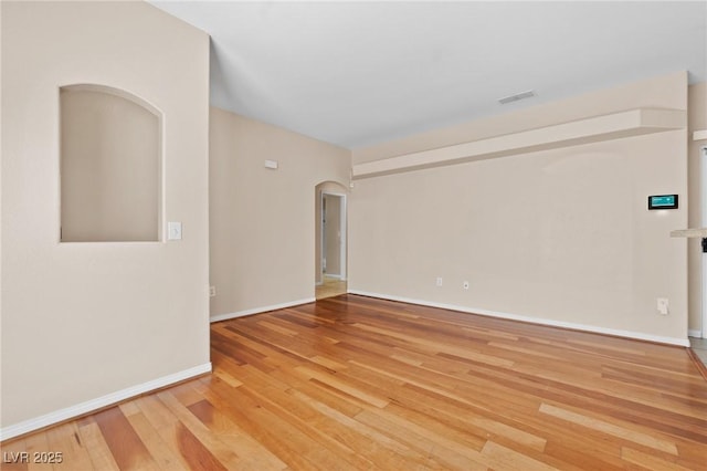 8409 Running Deer Ave Unit 203, Las Vegas, NV 89145 - unfurnished room featuring arched walkways and wood finished floors