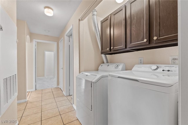 8409 Running Deer Ave Unit 203, Las Vegas, NV 89145 - laundry area featuring cabinet space, washing machine and clothes dryer, and light tile patterned floors