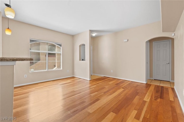 8409 Running Deer Ave Unit 203, Las Vegas, NV 89145 - unfurnished room featuring arched walkways and wood finished floors