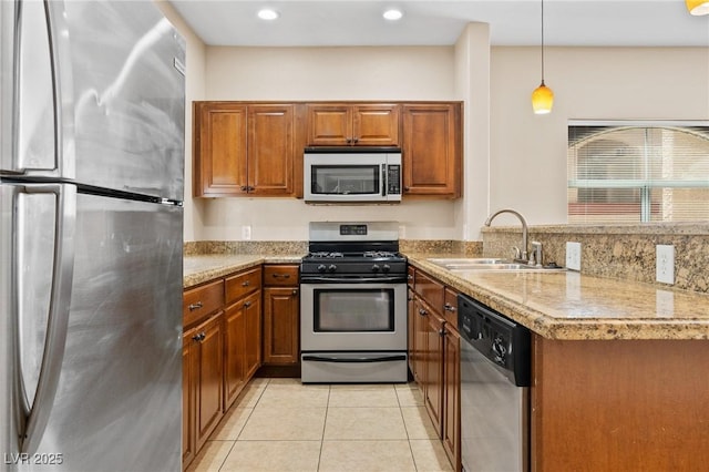 8409 Running Deer Ave Unit 203, Las Vegas, NV 89145 - kitchen with stainless steel appliances, brown cabinets, a peninsula, light tile patterned flooring, and recessed lighting