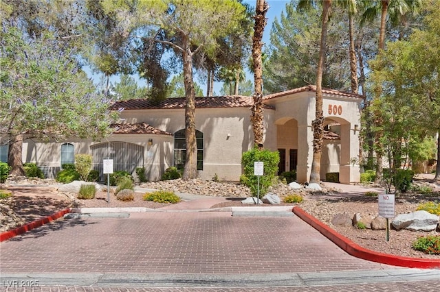 8409 Running Deer Ave Unit 203, Las Vegas, NV 89145 - view of front of property featuring a tiled roof and stucco siding