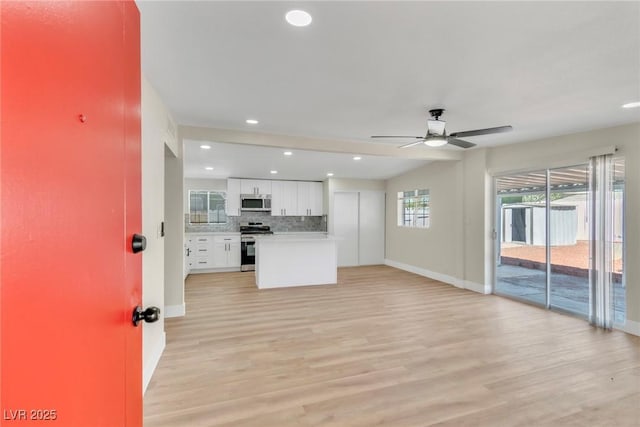 3212 Hickey Ave, North Las Vegas, NV 89030 - unfurnished living room featuring baseboards, a ceiling fan, light wood-type flooring, and recessed lighting