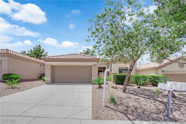 2323 Barbers Point Pl, Las Vegas, NV 89134 - view of front of house featuring driveway, stucco siding, a tiled roof, and an attached garage