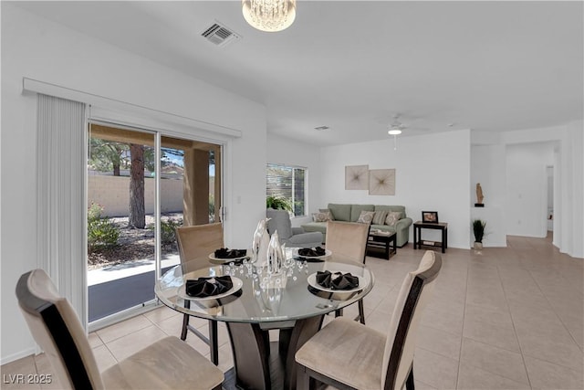 2323 Barbers Point Pl, Las Vegas, NV 89134 - dining room with light tile patterned floors, a ceiling fan, and a chandelier