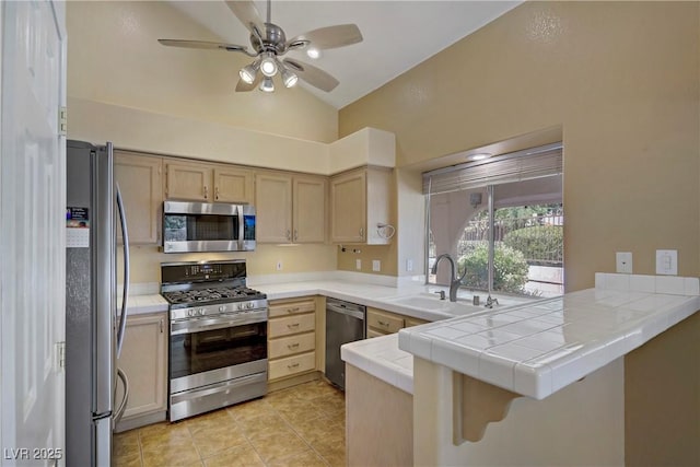 1305 Chaparral Summit Dr, Las Vegas, NV 89117 - kitchen featuring appliances with stainless steel finishes, a peninsula, ceiling fan, light brown cabinets, and high vaulted ceiling