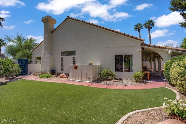 1305 Chaparral Summit Dr, Las Vegas, NV 89117 - rear view of house with ceiling fan, stucco siding, a patio, a tile roof, and a gate