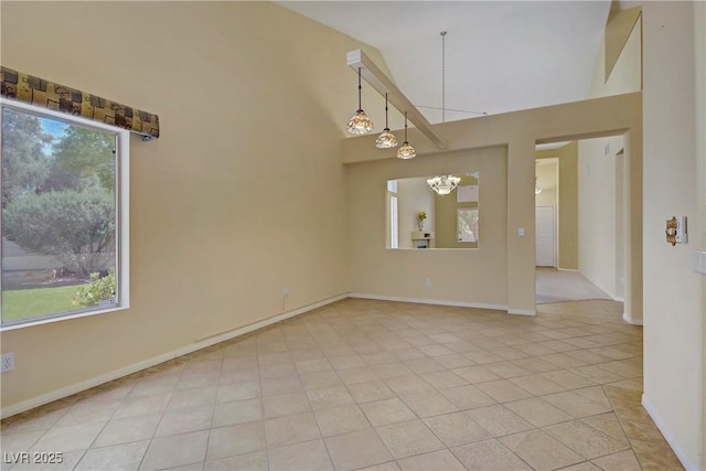 1305 Chaparral Summit Dr, Las Vegas, NV 89117 - unfurnished room featuring healthy amount of natural light, a chandelier, light tile patterned flooring, high vaulted ceiling, and baseboards