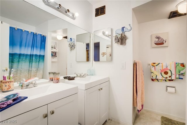 5706 W Lake Mead Blvd, Las Vegas, NV 89108 - bathroom featuring two vanities, baseboards, and tile patterned flooring