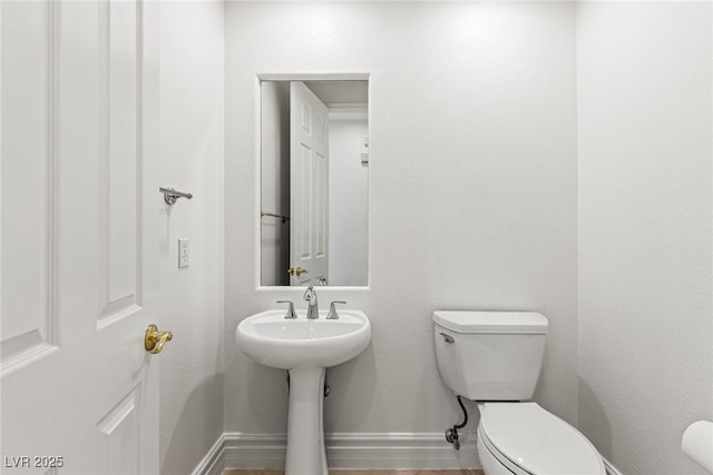2846 Barrow Downs St, Las Vegas, NV 89135 - half bathroom featuring toilet, baseboards, and a sink