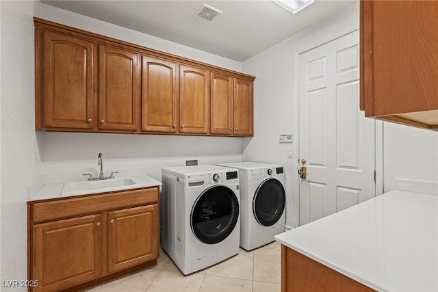 2846 Barrow Downs St, Las Vegas, NV 89135 - laundry room featuring cabinet space, separate washer and dryer, and light tile patterned floors