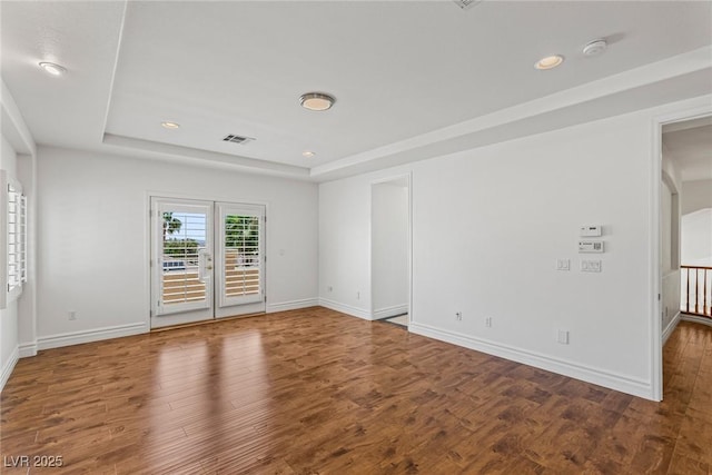 2846 Barrow Downs St, Las Vegas, NV 89135 - spare room featuring a tray ceiling, wood finished floors, baseboards, recessed lighting, and a smoke detector