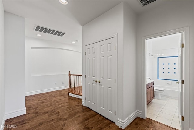 2846 Barrow Downs St, Las Vegas, NV 89135 - hallway with wood finished floors, baseboards, recessed lighting, and an upstairs landing