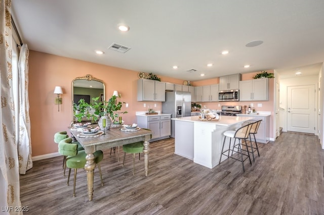 803 Calm Crystal Ct Lot 143, North Las Vegas, NV 89081 - kitchen featuring appliances with stainless steel finishes, wood finished floors, light countertops, a kitchen island with sink, and recessed lighting