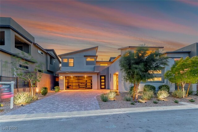 365 Crown Mesa Ave, Las Vegas, NV 89138 - contemporary house with stucco siding, an attached garage, and decorative driveway