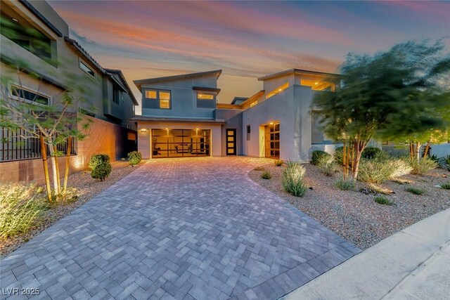 365 Crown Mesa Ave, Las Vegas, NV 89138 - modern home featuring stucco siding, decorative driveway, and an attached garage