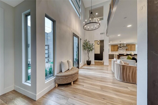 365 Crown Mesa Ave, Las Vegas, NV 89138 - hallway featuring healthy amount of natural light, light wood-style floors, baseboards, a towering ceiling, and recessed lighting