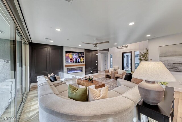 365 Crown Mesa Ave, Las Vegas, NV 89138 - living room featuring a glass covered fireplace, recessed lighting, and a ceiling fan