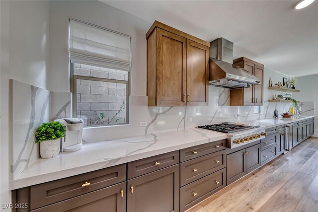 365 Crown Mesa Ave, Las Vegas, NV 89138 - kitchen with wall chimney exhaust hood, gas stovetop, open shelves, light wood-type flooring, and light stone counters