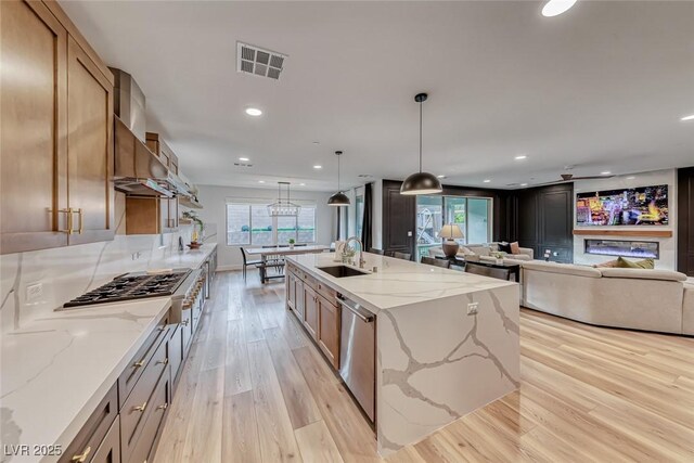 365 Crown Mesa Ave, Las Vegas, NV 89138 - kitchen with a sink, appliances with stainless steel finishes, light wood-style flooring, recessed lighting, and an island with sink